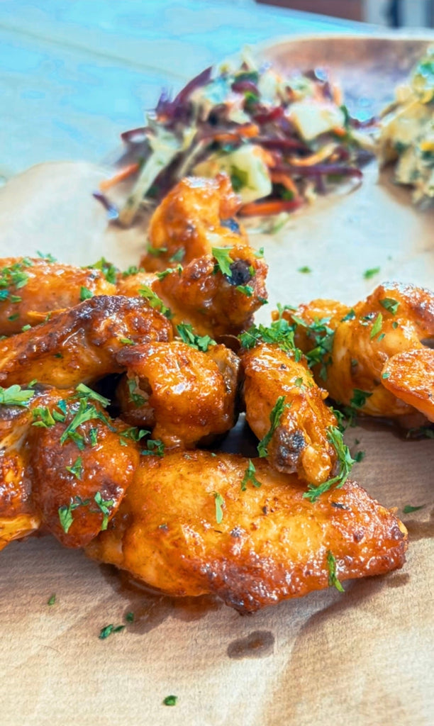 Oven-baked Sweet & Spicey - Swicy -Buffalo Chicken Wings glazed in spicy butter sauce, topped with herbs for a bold weeknight dinner.