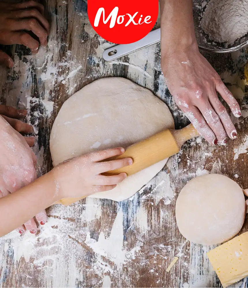 Hands rolling dough with fresh ingredients on a rustic table – Play with Your Food, Moxie blog hero image