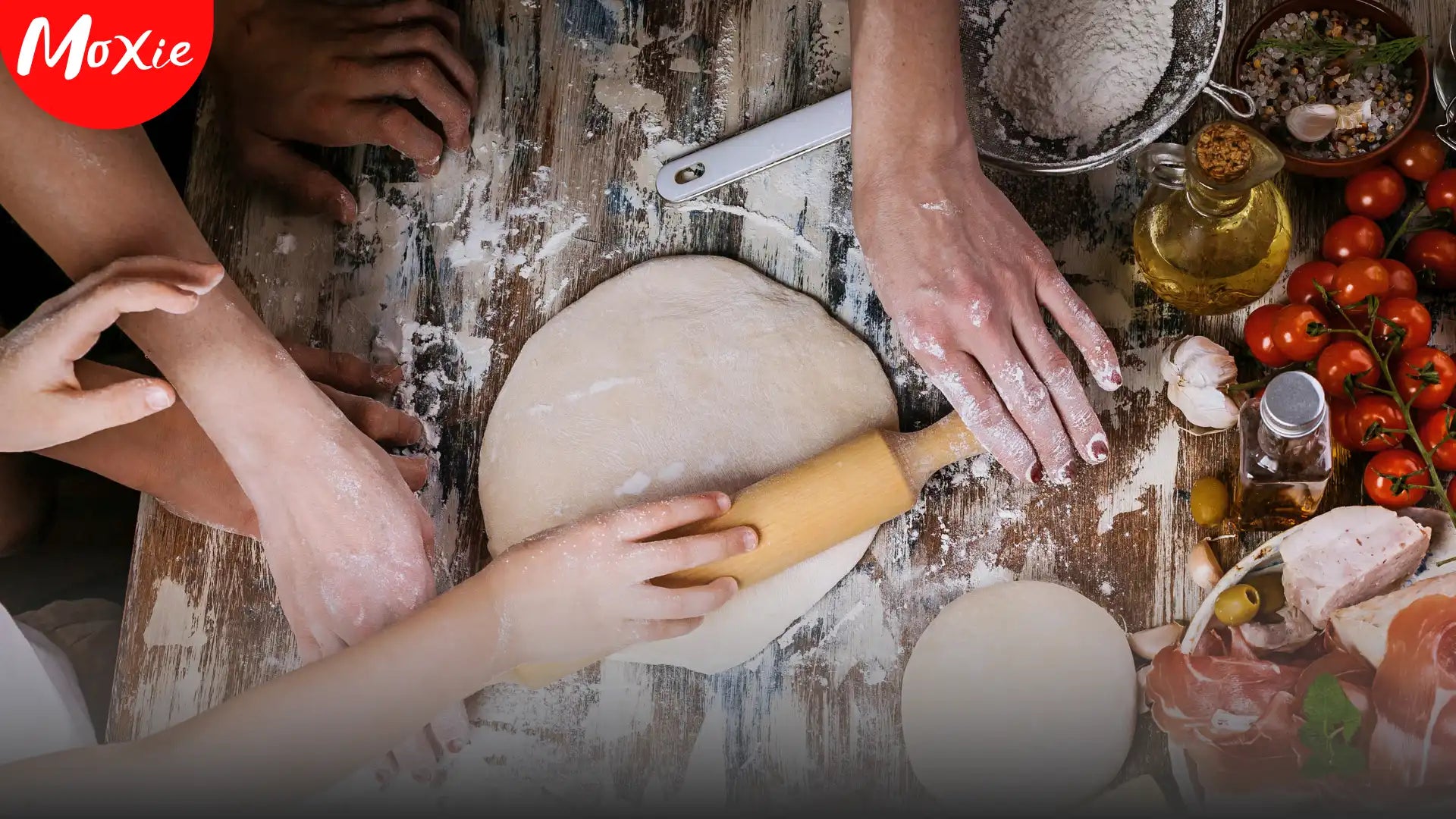 Hands rolling dough with fresh ingredients on a rustic table – Play with Your Food, Moxie blog hero image