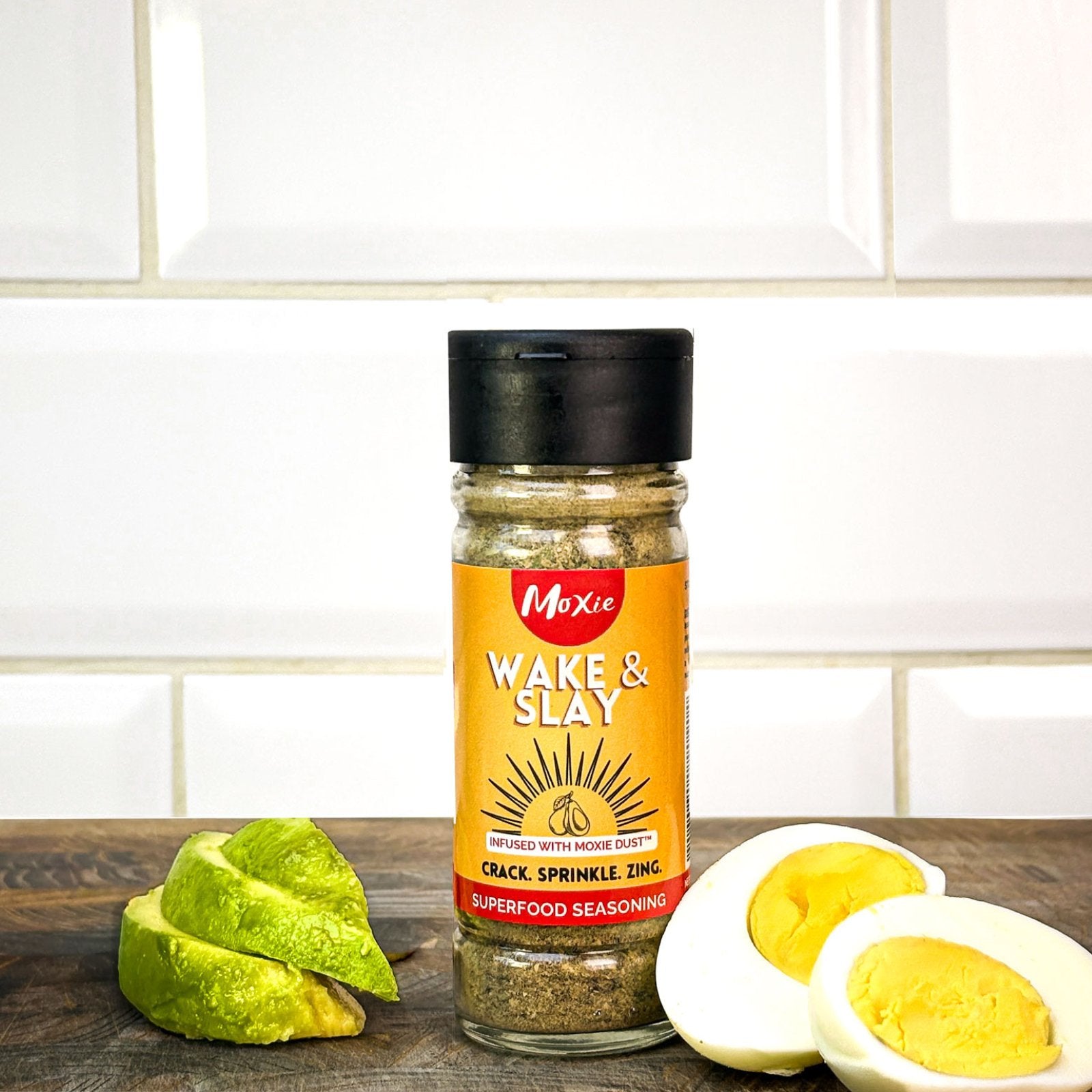 Moxie Wake & Slay Superfood Seasoning bottle on kitchen counter with avocado and egg